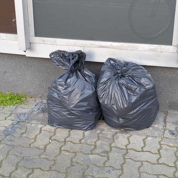 Deux sacs poubelles abandonnés sur un trottoir 