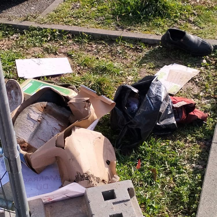 Déchets divers, bidon d'huile moteur à proximité d'une clôture de chantier